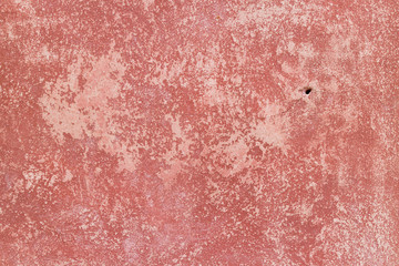Crack red painted wall texture background.