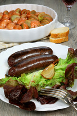 French cuisine: black pudding with baked onions and wineglass
