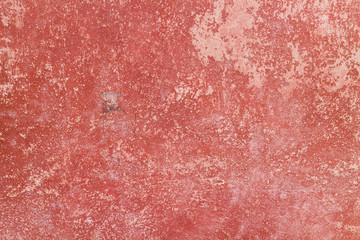 Crack red painted wall texture background.