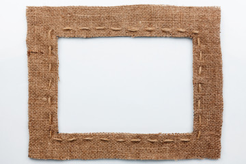 Frame of burlap, lies on a white background