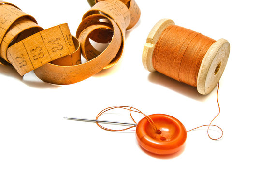 Orange Spool Of Thread, Meter And Button