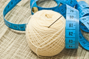 white yarn with needle and meter closeup