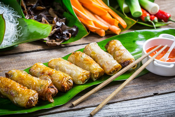 Fried spring rolls surrounded by ingredients