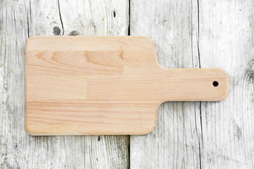 empty cutting board on dark wooden planks