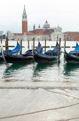Venetian gondolas with high tide.