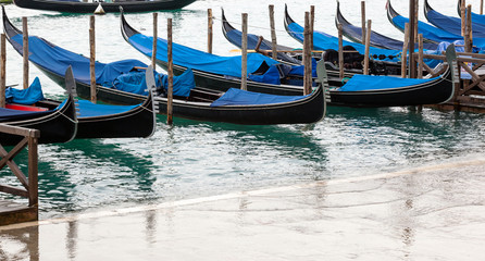 Fototapeta na wymiar Venetian gondolas with high tide.