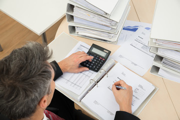 Fototapeta na wymiar Businessman Calculating Invoices