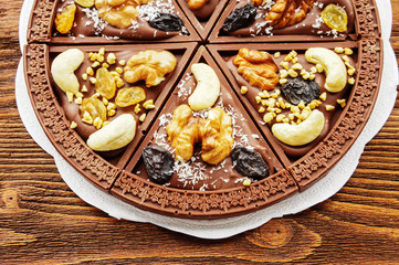 Dessert chocolate pizza with raisins and nuts