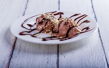 Chocolate ice cream with cashews and chocolate syrup