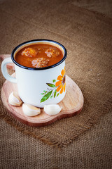 Fresh tomato soup on sackcloth background
