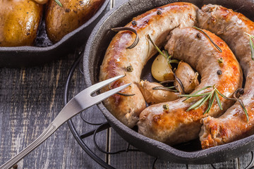 Rustic style potatoes and fried sausages