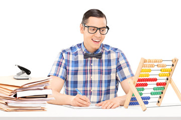 Man counting on abacus and writing down some notes