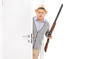 Senior with rifle bursting through a door