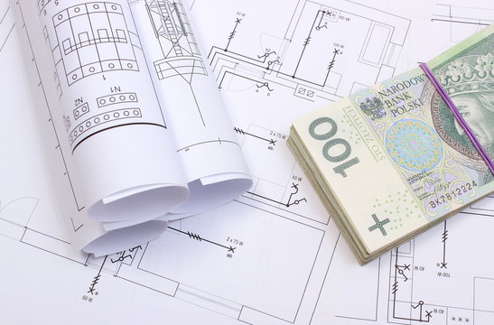 banknotes and electrical diagrams on construction drawing