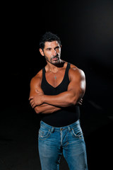 Fototapeta na wymiar Handsome Muscled man in jeans over black background