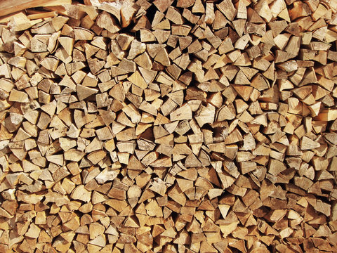 Background of dry chopped firewood logs