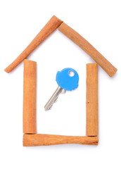 Cinnamon sticks and shape of house with key