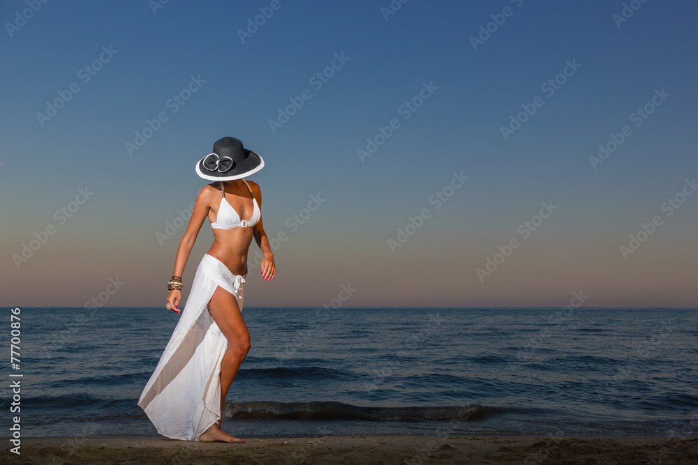 Wall mural woman with white sarong  on the beach