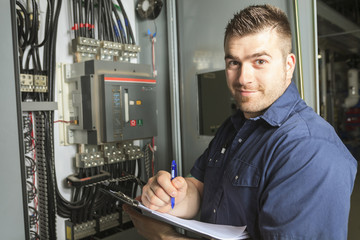 Portrait of an happy worker in a factory - obrazy, fototapety, plakaty