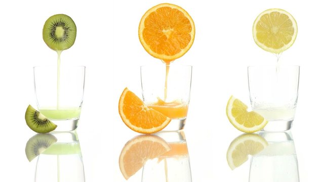 Juice orange lemon kiwi poured into glass