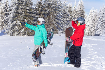 Girl with snowboard  preparing to ride from the hill