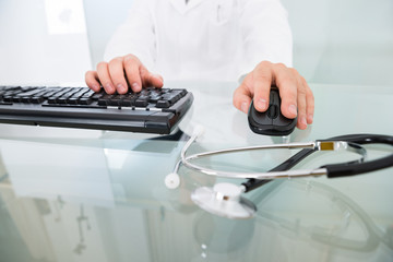 Close-up Of Doctor Using Computer