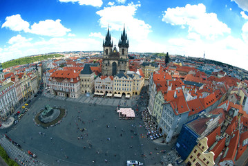 Fototapeta na wymiar Houses with traditional red roofs in Prague Old Town Square in t
