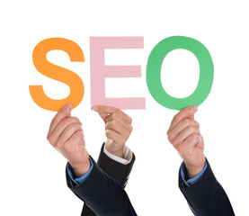 Multiple Hands Holding SEO Word