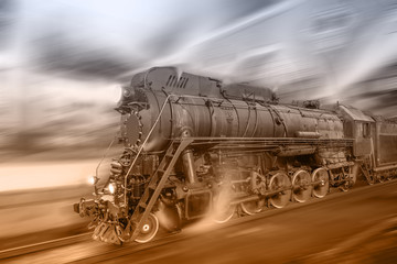 Steam train goes fast on the night station background.