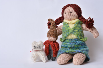 Studio shot of Waldorf handmade family toys, mother, child and a cat at home made by wool