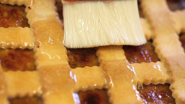 Brush glaze the cake in pastry