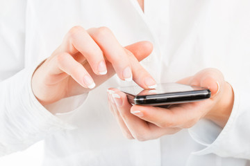 Business woman with young hands and beautiful nails using mobile