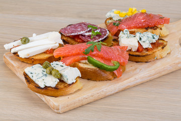 Tapas with cheese, salami and salmon