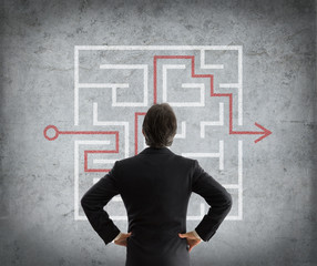 businessman solves complicated maze