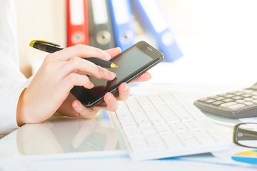 business woman take gadget phone in office