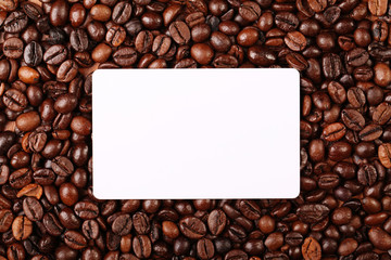 Against the backdrop of coffee beans is a business card