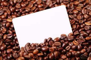 Against the backdrop of coffee beans is a business card