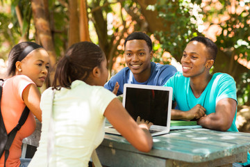group of students using laptop computer