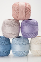 Set Of Cotton Crocheting Thread Bobbins on Wooden Table