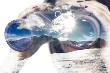 Double exposure of binoculars and mountainscape