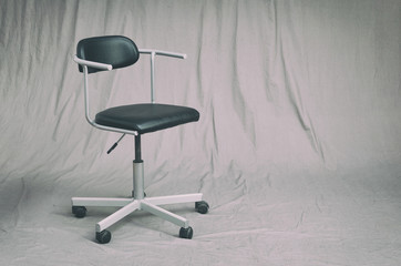 office chair on a grungy gray studio background