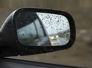 Driving in rain with side mirrorwith drops