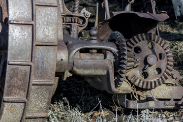 Rusted farm equipment in the weeds