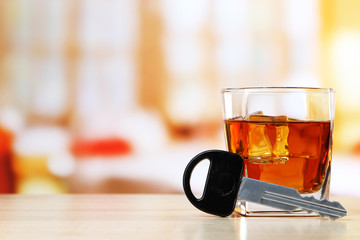 Composition with car key and glass of whiskey,