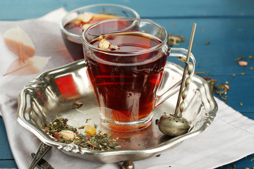 Beautiful vintage composition with herbal tea, on wooden table