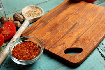 Different spices and herbs with cutting board