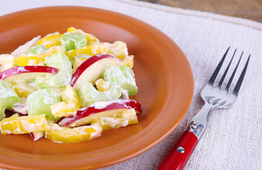 Waldorf salad with salad pepper on plate on table close up