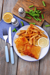 Breaded fried fish fillets and potatoes with asparagus and