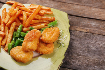 Breaded fried chicken nuggets and potatoes with asparagus