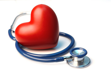 Stethoscope with heart on light background